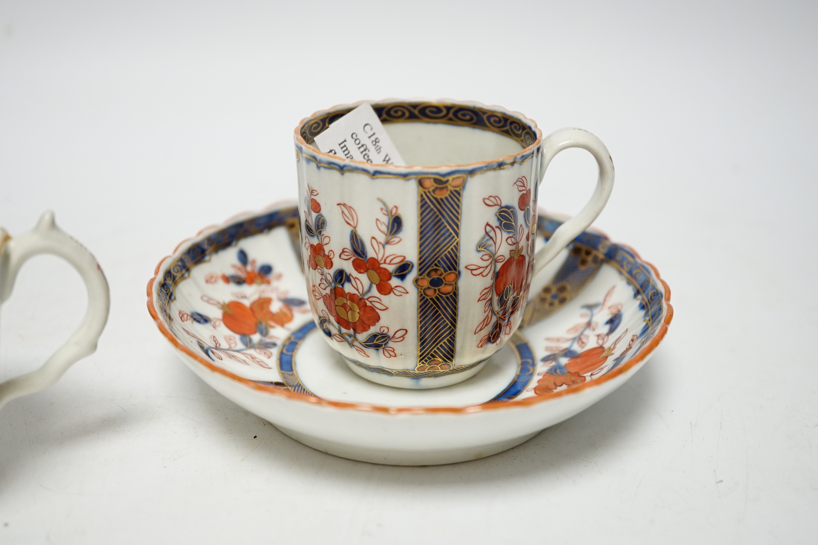 A Worcester ‘low Chelsea ewer’ milk jug, c.1770 and a Worcester Japan pattern coffee cup and saucer, c.1780, jug 6.5cm
